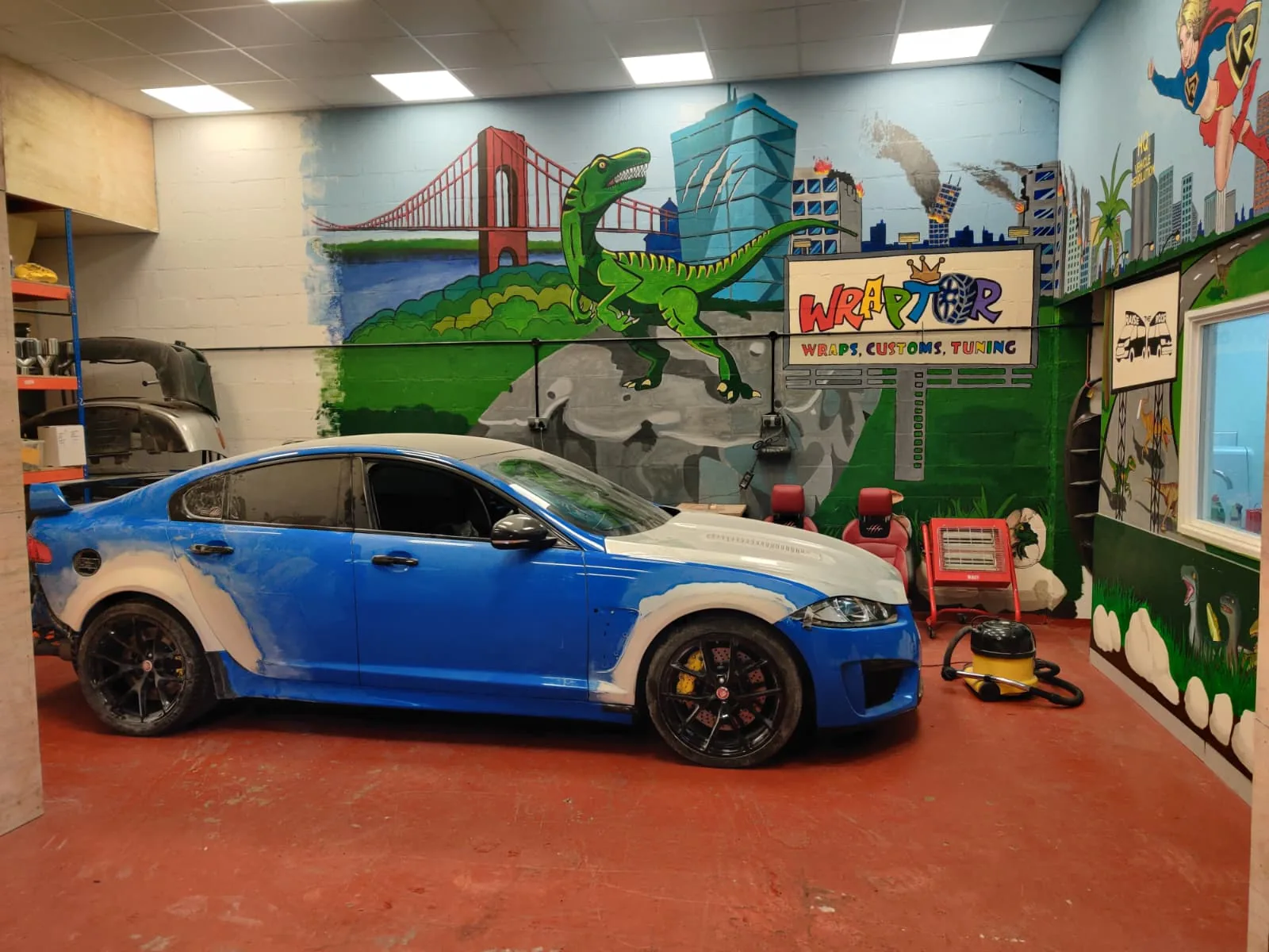 A custom-wrapped Jaguar XFR inside the Wraptor Tuning workshop in Alcester